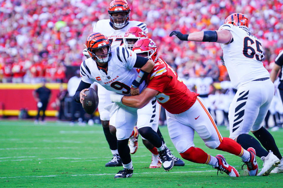 Sep 15, 2024; Kansas City, Missouri, USA; Cincinnati Bengals quarterback Joe Burrow (9) is sacked by Kansas City Chiefs defensive end George Karlaftis (56) during the first half at GEHA Field at Arrowhead Stadium. Mandatory Credit: Denny Medley-Imagn Images