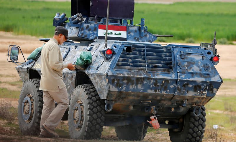 FILE PHOTO: Iranian Revolutionary Guard Commander Soleimani walks near an armoured vehicle at the frontline during offensive operations against Islamic State militants in the town of Tal Ksaiba