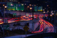 In this image made with a long exposure, motor vehicles move along Interstate 76 ahead of the Thanksgiving Day holiday in Philadelphia, Wednesday, Nov. 22, 2023. (AP Photo/Matt Rourke)