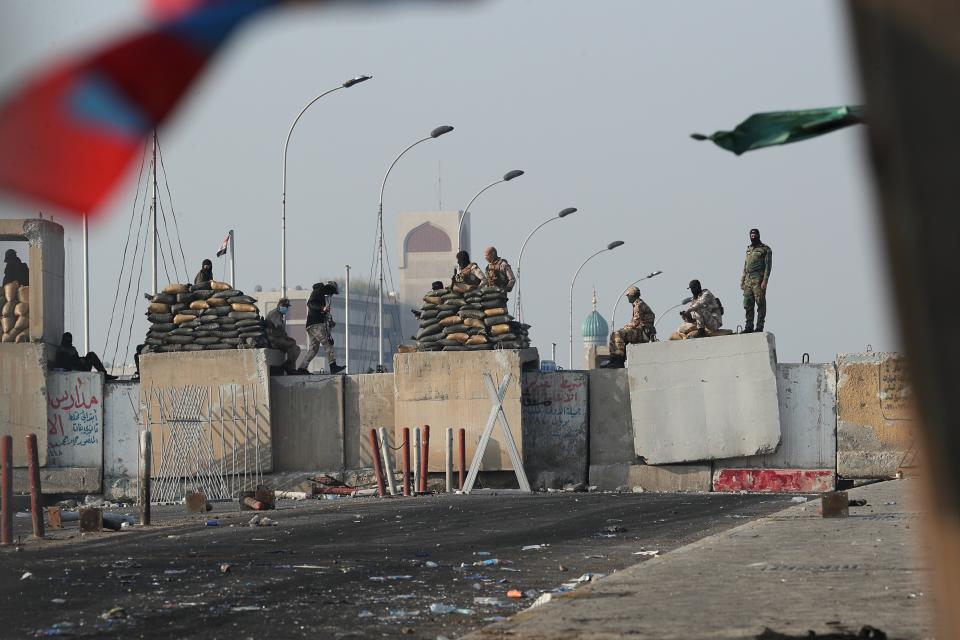 Iraqi security forces close the Al-Sanak Bridge leading to the Green Zone during a demonstration in Baghdad, Iraq, Thursday, Oct. 31, 2019. Late Wednesday, hundreds of people headed to the Al-Sanak Bridge that runs parallel to the Joumhouriya Bridge, opening a new front in their attempts to cross the Tigris River to the Green Zone. Security forces fired volleys of tear gas that billowed smoke and covered the night sky. (AP Photo/Hadi Mizban)