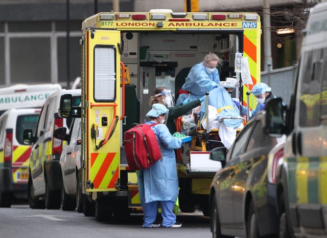 Paramedics and hospital staff attend to a patient outside the Royal London Hospital