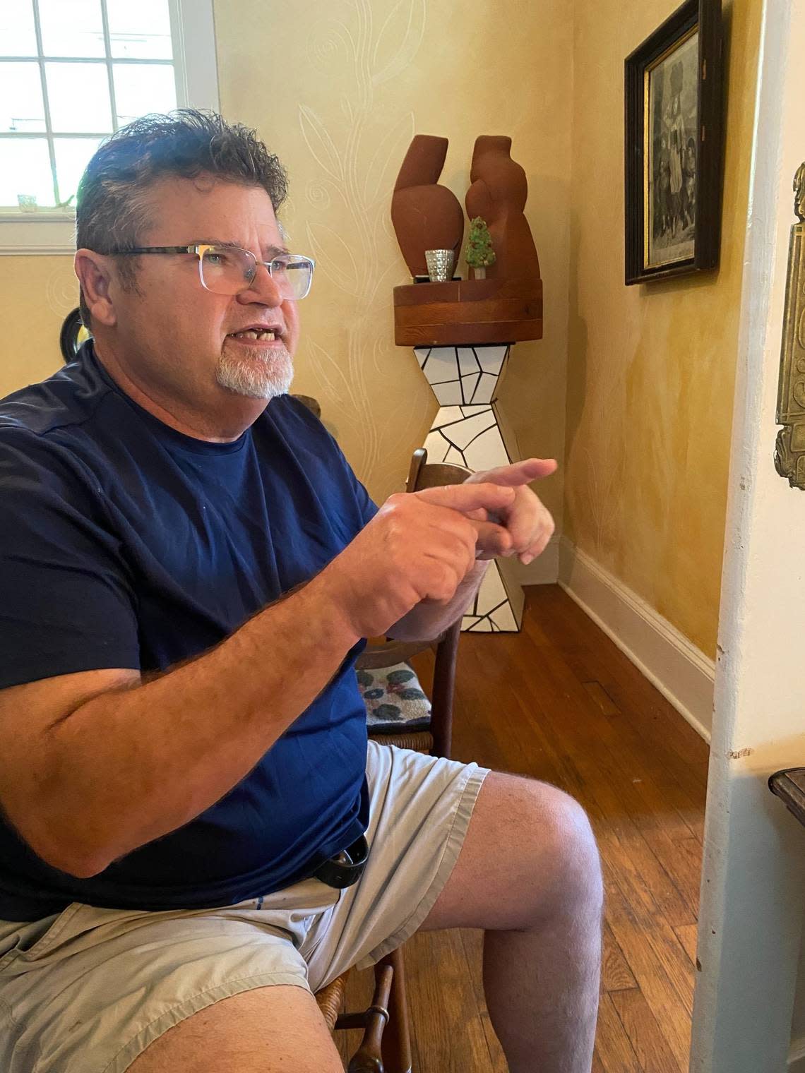 Will Hinton shows off a sculpture he made based on dancing with his wife, displayed in their home in Louisburg, where he is now retired as an art professor at Louisburg College.