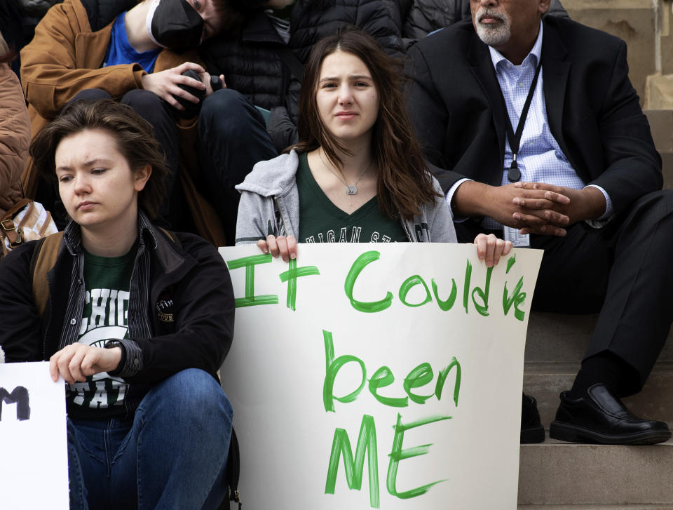 Demonstrators hold signs to protest gun violence at a student sit-in at the Michigan Capitol building following Monday's mass shooting at Michigan State University, Wednesday, Feb. 15, 2023, in Lansing, Mich. (Brice Tucker/The Flint Journal via AP)