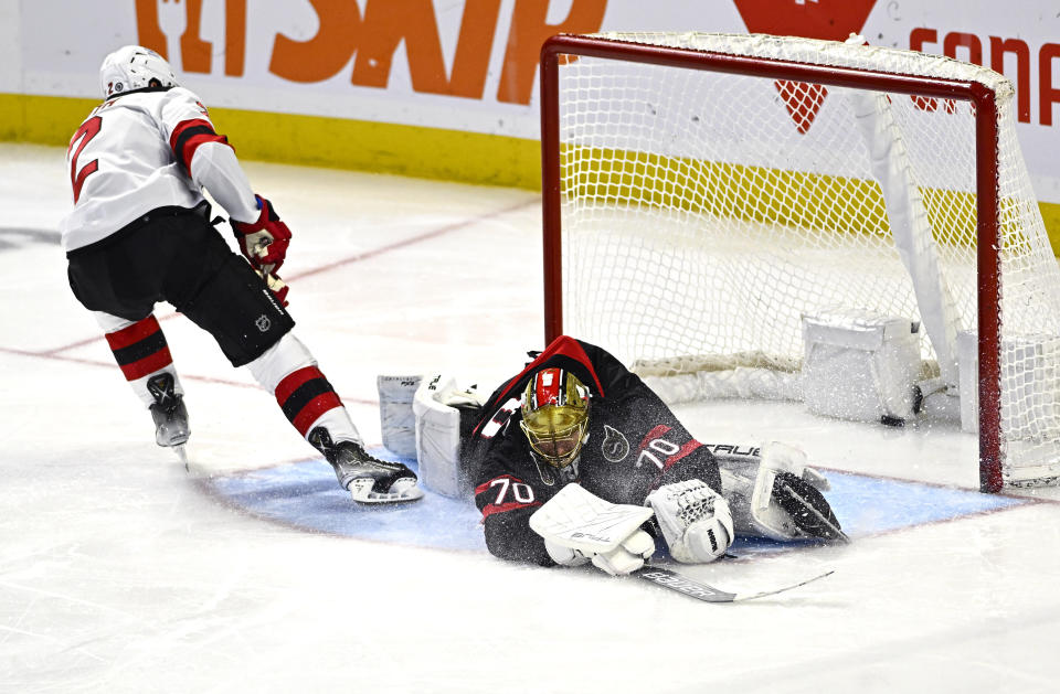 New Jersey Devils defenseman Brendan Smith (2) scores on Ottawa Senators goaltender Joonas Korpisalo (70) during the third period of an NHL hockey game, Friday, Dec. 29, 2023 in Ottawa, Ontario. (Justin Tang/The Canadian Press via AP)