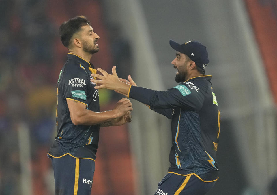 Gujrat Titans' Mohit Sharma,l eft, celebrates the wicket Mumbai Indians' Suryakumar Yadav of during the Indian Premier League qualifier cricket match between Gujarat Titans and Mumbai Indians in Ahmedabad, India, Friday, May 26, 2023. (AP Photo/Ajit Solanki)