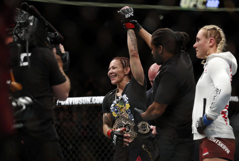 Cris “Cyborg” Justino celebrates her victory over Yana Kunitskaya (R), during a featherweight title mixed martial arts bout at UFC 222 on Saturday, March 3, 2018, in Las Vegas. (AP)