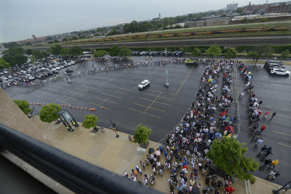 Lines of fans wait to go through added security at Guaranteed Rate Field after a Fourth of July parade shooting in nearby Highland Park, Ill., Monday, July 4, 2022, in Chicago before a baseball game between the Chicago White Sox and the Minnesota Twins. (AP Photo/Paul Beaty)