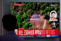 A man walks past a TV broadcasting a news report on the dismantling of the Punggye-ri nuclear testing site, in Seoul, South Korea, May 24, 2018. REUTERS/Kim Hong-Ji