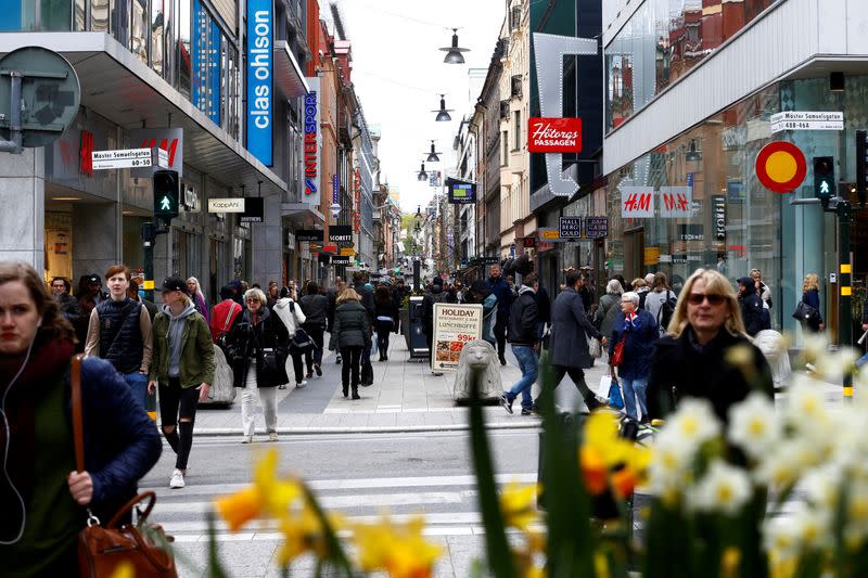FILE PHOTO: People walk through the shopping area on the pedestrian street Drottninggatan in Stockholm