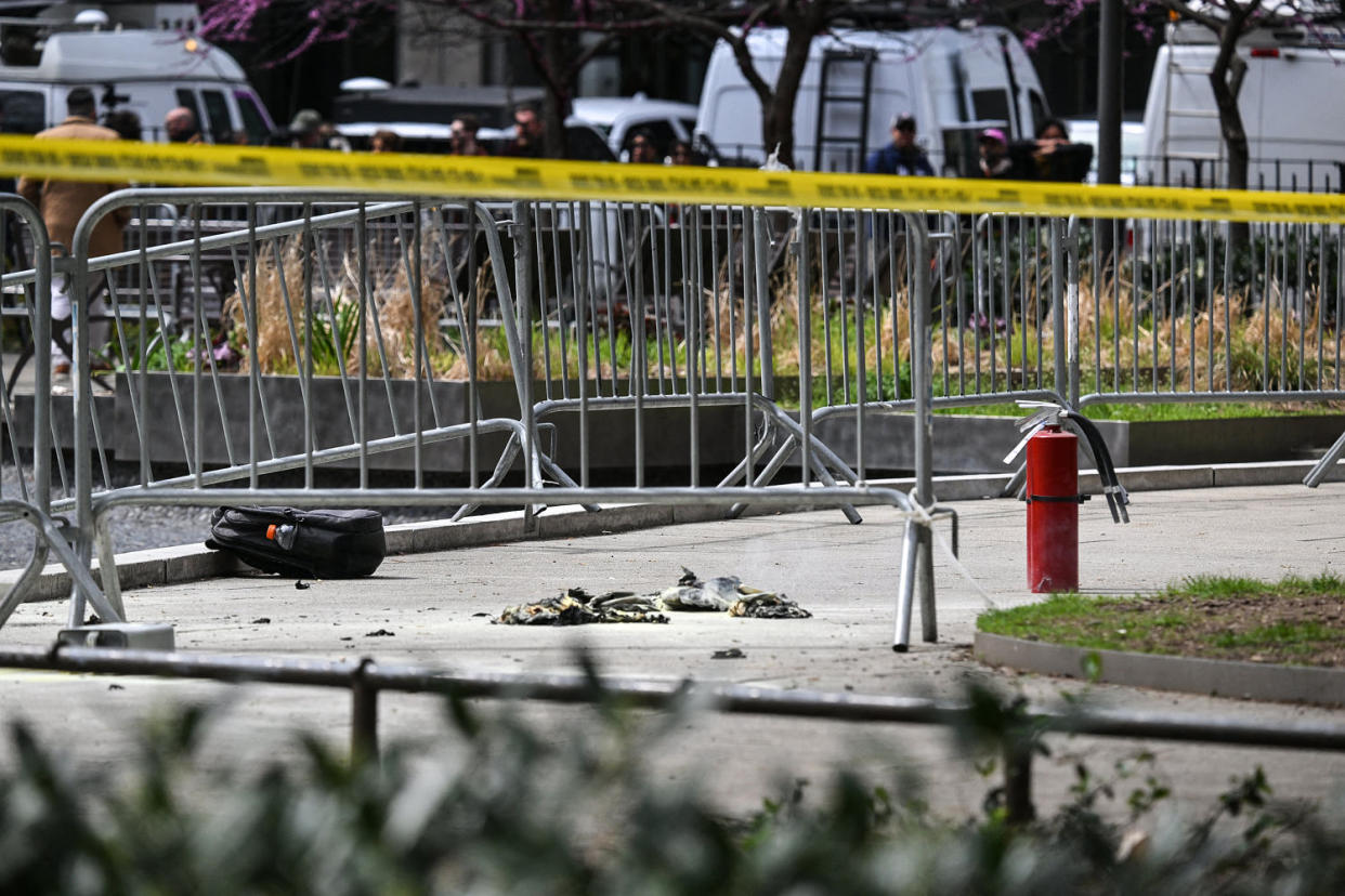 Image: Fire extinguishers are left at the park across from Manhattan Criminal Court in New York City after a man reportedly set himself on fire (Angela Weiss / AFP - Getty Images)