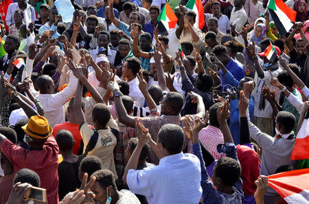 Sudanese demonstrators celebrate after Defence Minister Awad Ibn Auf stepped down as head of the country's transitional ruling military council, as protesters demanded quicker political change, near the Defence Ministry in Khartoum, Sudan April 13, 2019. REUTERS/Stringer