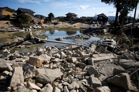 Submerged and destroyed houses are seen near the site where river banks were broken along Suemasa river in Mabi town in Kurashiki, Okayama Prefecture, Japan, July 9, 2018. REUTERS/Issei Kato