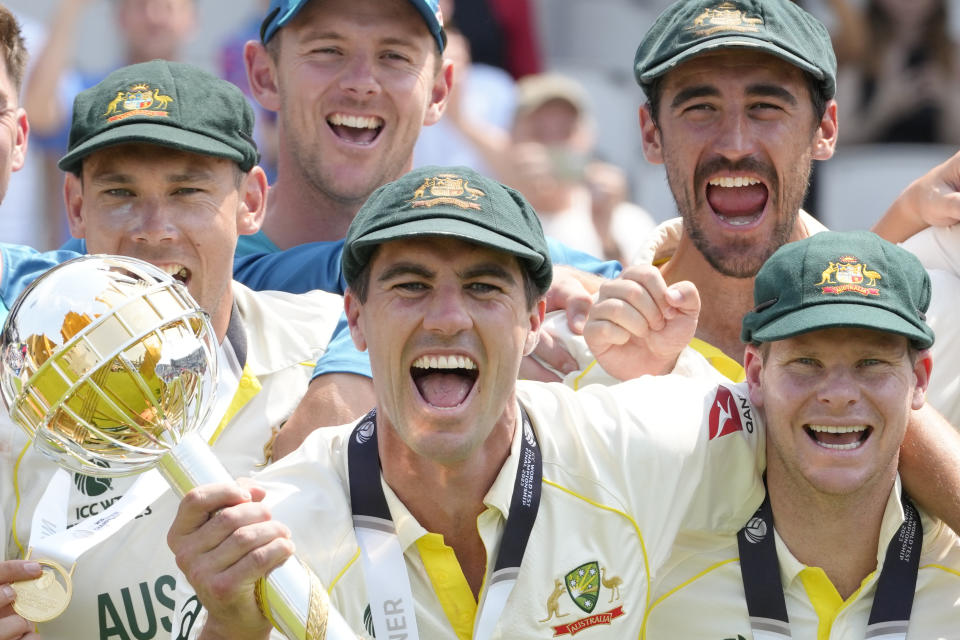 The Australian team celebrate as captain Pat Cummins holds the winners trophy during the victory ceremony for the ICC World Test Championship Final at The Oval cricket ground in London, Sunday, June 11, 2023. Australian defeated India on the last day of the test. (AP Photo/Kirsty Wigglesworth)