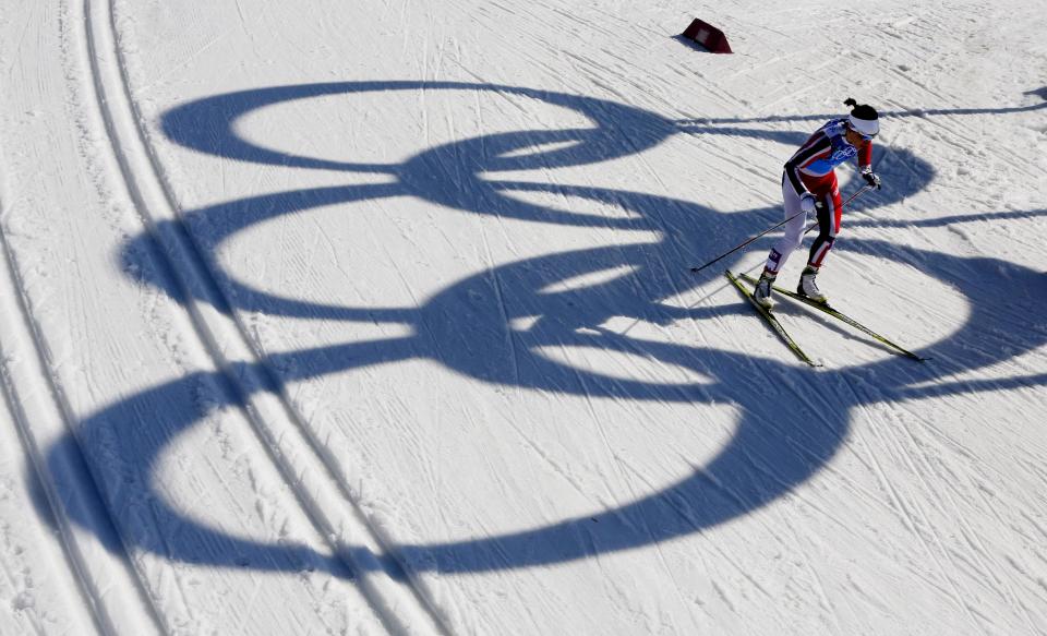 Norway's Marit Bjoergen skis past the Olympic rings during the women's 4x5K cross-country relay at the 2014 Winter Olympics, Saturday, Feb. 15, 2014, in Krasnaya Polyana, Russia. (AP Photo/Dmitry Lovetsky)