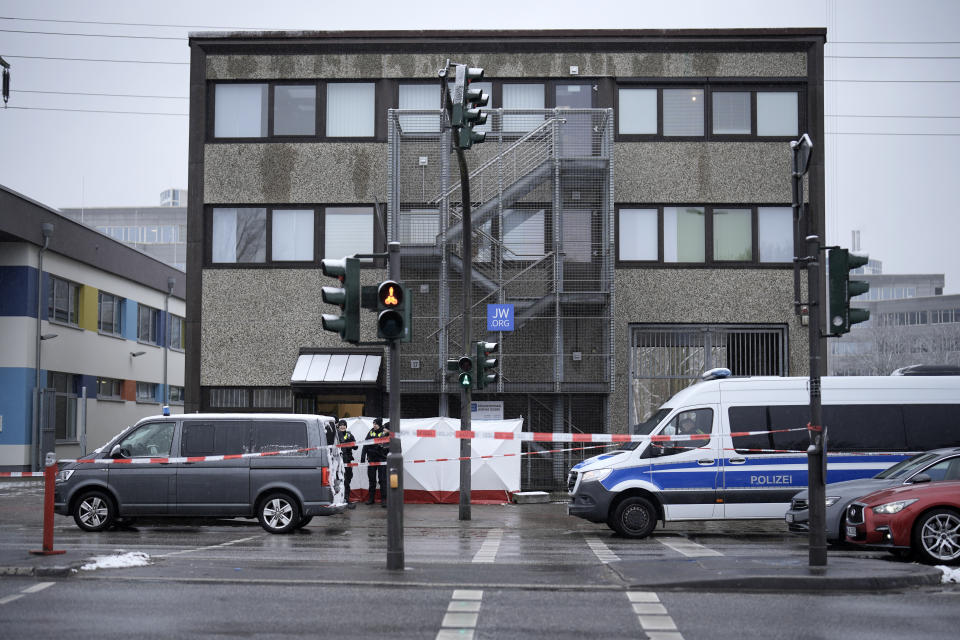 Police secured a street outside a Jehovah's Witness building in Hamburg, Germany Friday, March 10, 2023. Shots were fired inside the building used by Jehovah's Witnesses in the northern German city of Hamburg on Thursday evening, with multiple people killed and wounded, police said. (AP Photo/Markus Schreiber)