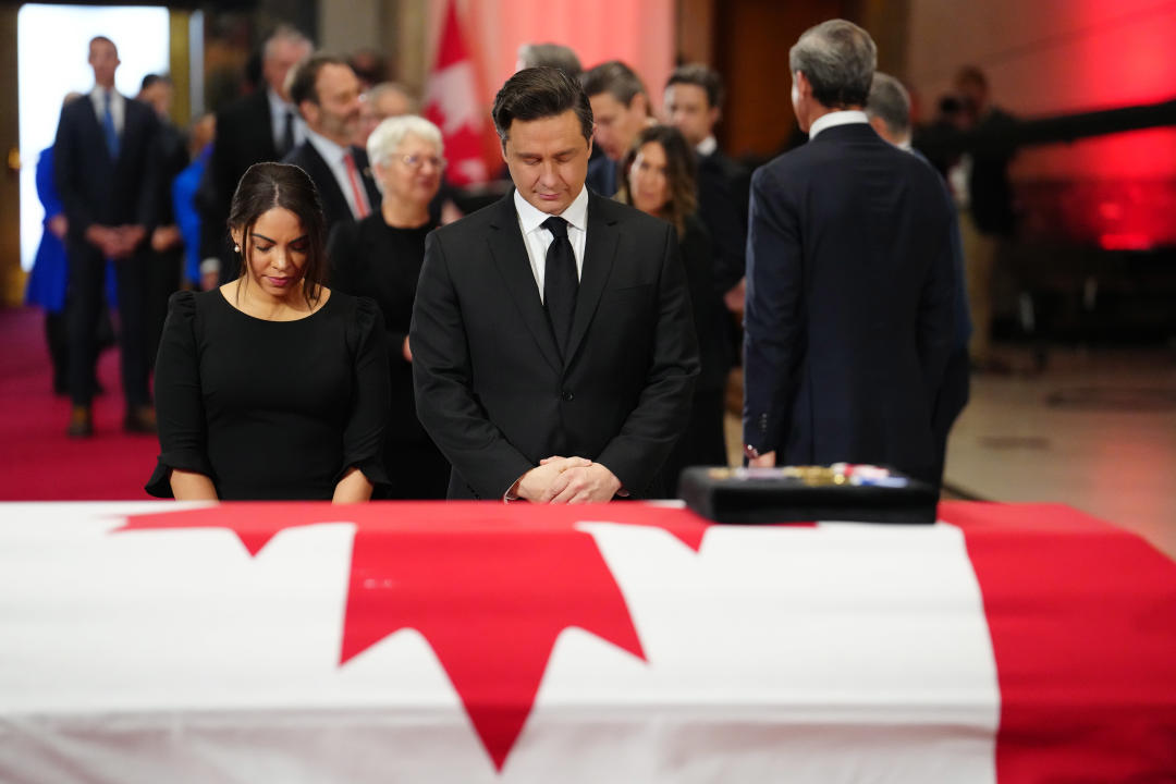 Conservative Leader Pierre Poilievre and his wife Anaida payrespects at the casket of former prime minister Brian Mulroney as he lies in state at the Sir John A. Macdonald building opposite Parliament Hill in Ottawa on Tuesday, March 19, 2024. THE CANADIAN PRESS/Sean Kilpatrick