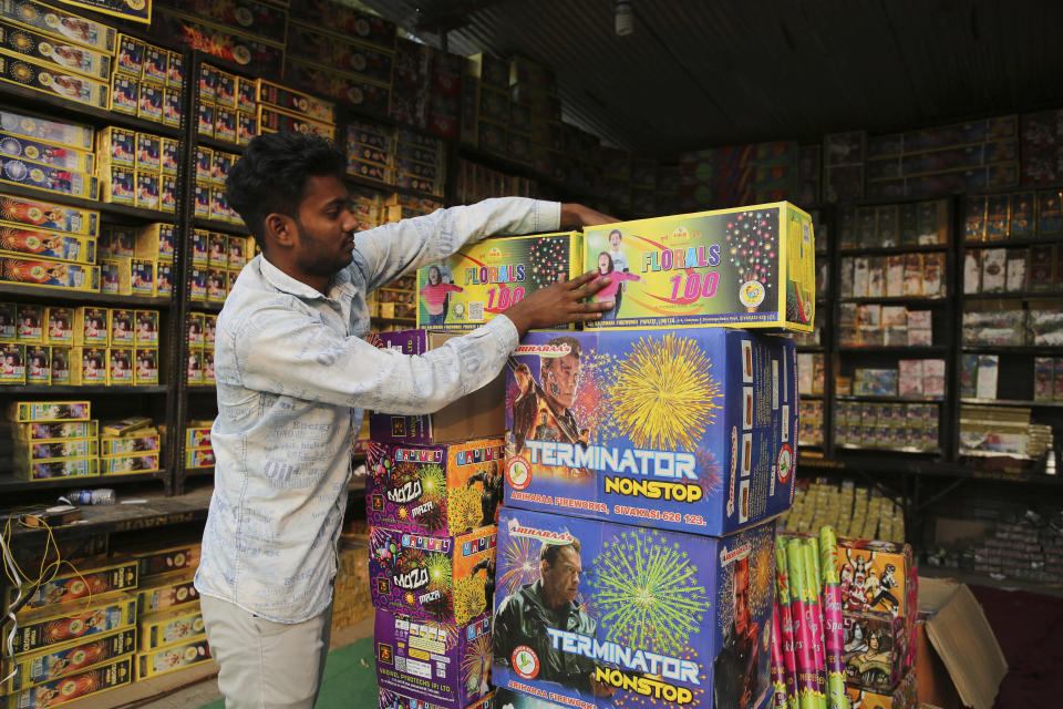 A man arranges packets of firecracker for sale on the eve of Diwali, the Hindu festival of lights, in Jammu, India, Wednesday, Nov. 3, 2021. Diwali is one of Hinduism's most important festivals, dedicated to the worship of the goddess of wealth Lakshmi. (AP Photo/Channi Anand)