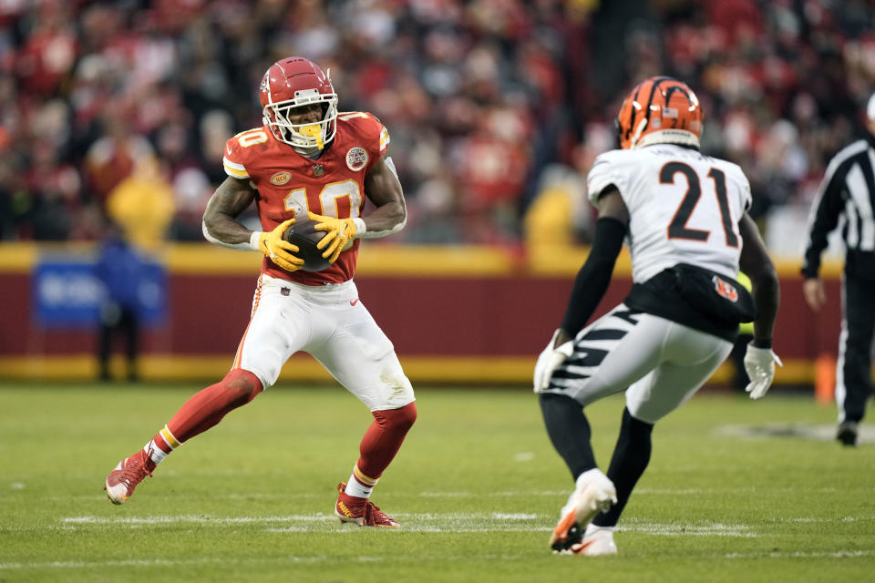Kansas City Chiefs running back Isiah Pacheco (10) runs with the ball as Cincinnati Bengals cornerback Mike Hilton (21) defends during the first half of an NFL football game Sunday, Dec. 31, 2023, in Kansas City, Mo. (AP Photo/Charlie Riedel)