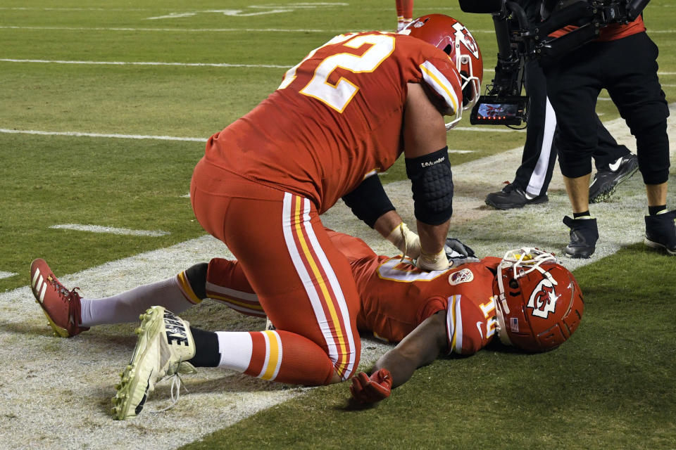 Kansas City Chiefs offensive lineman Eric Fisher (72) pretends to do CPR on wide receiver Tyreek Hill (10) after Hill scores a touchdown during the second half of an NFL football game against the Cincinnati Bengals in Kansas City, Mo., Sunday, Oct. 21, 2018. The Chiefs won, 45-10. (AP Photo/Reed Hoffmann)