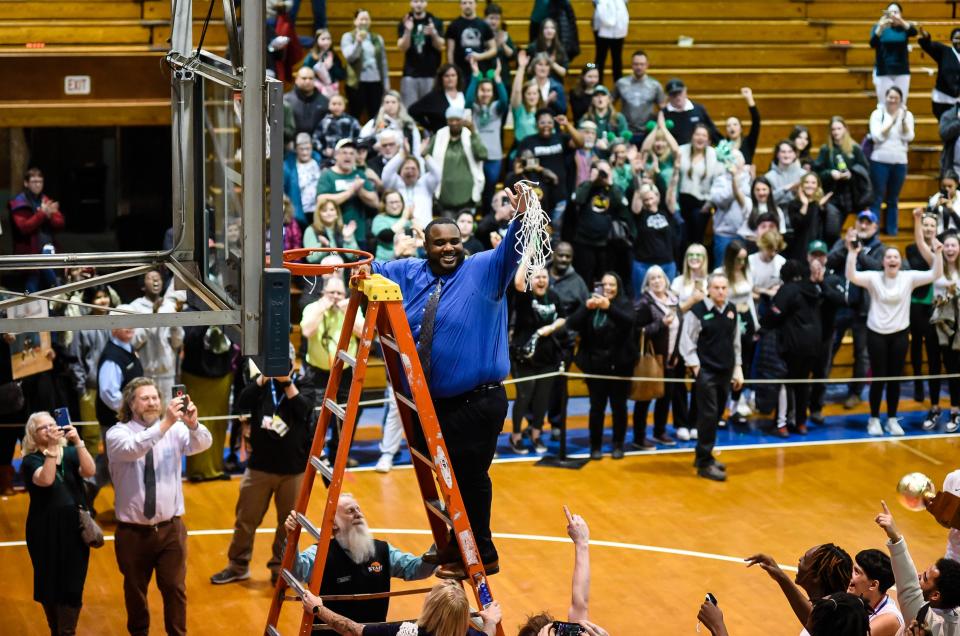 Winooski High School boys basketball coach Sam Jackson celebrates his team's Division III state title at Barre Auditorium on March 11, 2023.