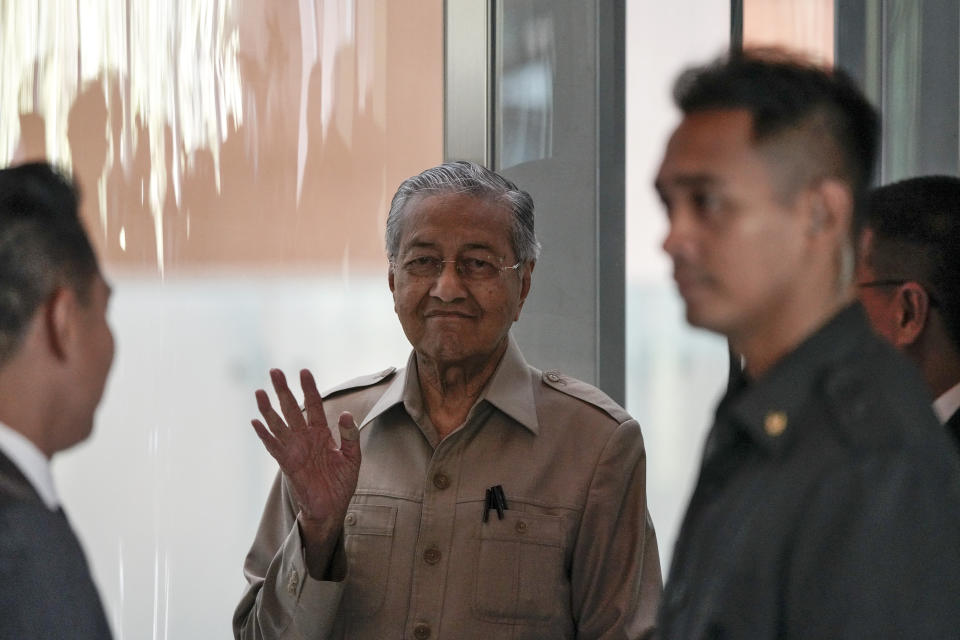 Malaysia's interim leader Mahathir Mohamad, center, waves as he leaves after delivering a speech at the committee on the exercise of the inalienable rights of the Palestinian people, in Kuala Lumpur, Malaysia, Friday, Feb. 28, 2020. The speaker of Malaysia's House rejected Mahathir Mohamad's call for a vote next week to chose a new premier, deepening the country's political turmoil after the ruling alliance collapsed this week. (AP Photo/Vincent Thian)