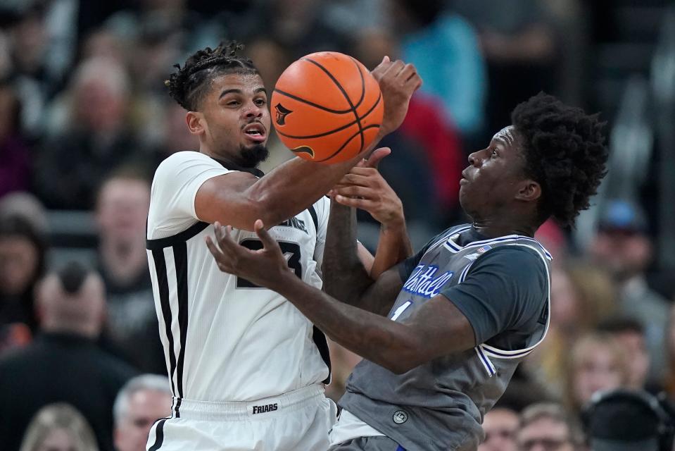 Providence forward Bryce Hopkins, left, and Seton Hall guard Kadary Richmond, right, vie for the ball during the first half of an NCAA college basketball game Wednesday, Jan. 3, 2024, in Providence, R.I. (AP Photo/Steven Senne)