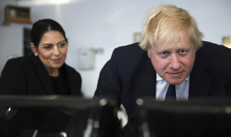 Britain's Prime Minister Boris Johnson and Home Secretary Priti Patel visit a security control room in Port of Southampton, England, Monday Dec. 2, 2019, ahead of the general election on Dec. 12. (Hannah McKay/Pool via AP)