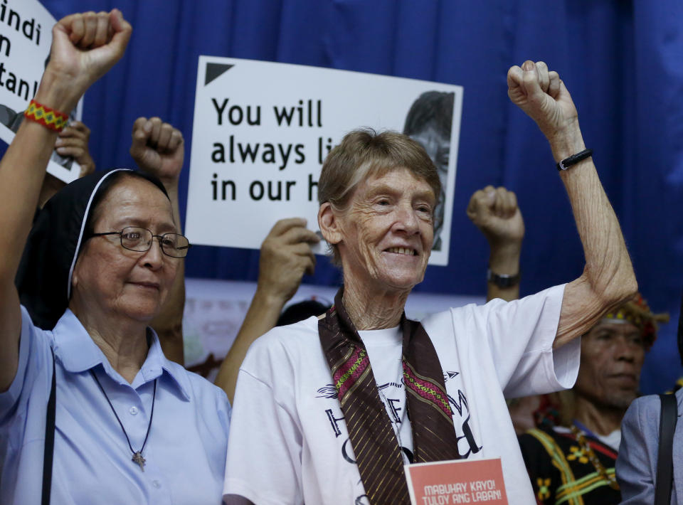 Australian Roman Catholic nun Sister Patricia Fox, right, clenches her fist following a news conference hours before her departure for Australia Saturday, Nov. 3, 2018, in Manila, Philippines. Sister Fox decided to leave after 27 years in the country after the Immigration Bureau denied her application for the extension of her visa. The Philippine immigration bureau has ordered the deportation of Fox who has angered the president by joining anti-government rallies. (AP Photo/Bullit Marquez)