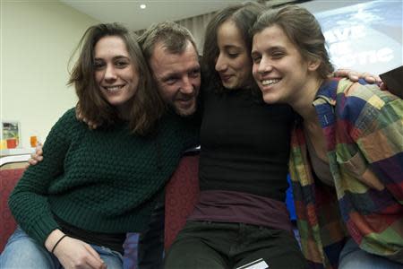 (From L) Greenpeace International activists Alex Harris of Britain, Phil Ball of Britain, Faiza Oulahsen of Netherlands and Camila Speziale of Argentina, show their relief following a decision by the Russian Parliament adopting an amnesty ending legal proceedings against the Arctic 30, in this December 18, 2013 handout from Greenpeace. REUTERS/Dmitri Sharomov/Greenpeace/Handout via Reuters