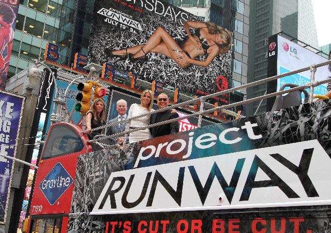 Nina Garcia, from left, Tim Gunn, Heidi Klum and designer Michael Kors pose for photos while promoting the launch of the new season of "Project Runway" in New York's Times Square on Thursday, July 19, 2012. The fashion competition series, now in it's tenth season, premieres Thursday at 9 p.m. EST on Lifetime. (Photo by Donald Traill/Invision/AP)