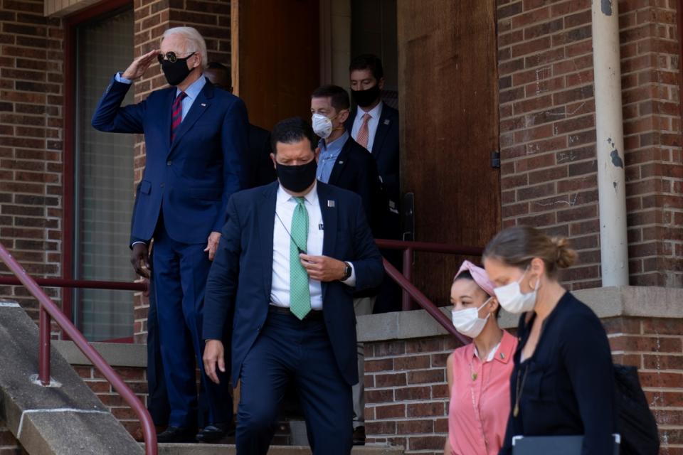  Joe Biden salutes people across the street at he leaves a news conference site in Wilmington, Del., on Sept. 4, 2020.  