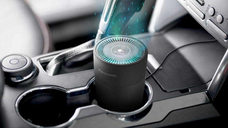 The Panasonic nanoe X Air Purifier in a vehicle's cup holder with a simulated air purifying effect applied.