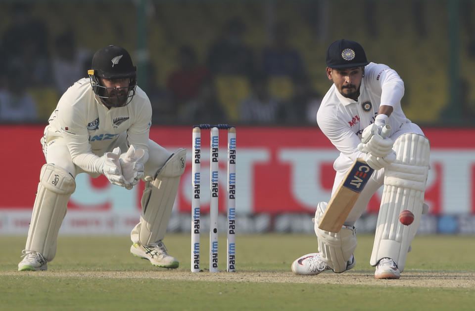 India's Shreyas Iyer plays a defensive shot during the day one of their first test cricket match with New Zealand in Kanpur, India, Thursday, Nov. 25, 2021. (AP Photo/Altaf Qadri)