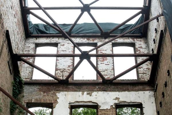 The facade remains at ReSurfaced giving the plaza a touchstone to its history and providing a unique view in downtown Louisville. 5/29/15