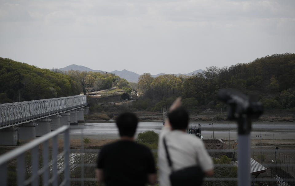 Visitors look on the northern side at the Imjingak Pavilion in Paju, South Korea, Sunday, April 26, 2020. A train likely belonging to North Korean leader Kim Jong Un has been parked at his compound on the country's east coast since last week, satellite imagery showed, amid speculation about his health that has been caused, in part, by a long period out of the public eye. (AP Photo/Lee Jin-man)