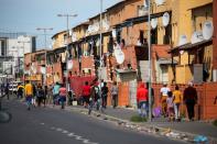 People walk down a street in Langa township, Cape Town