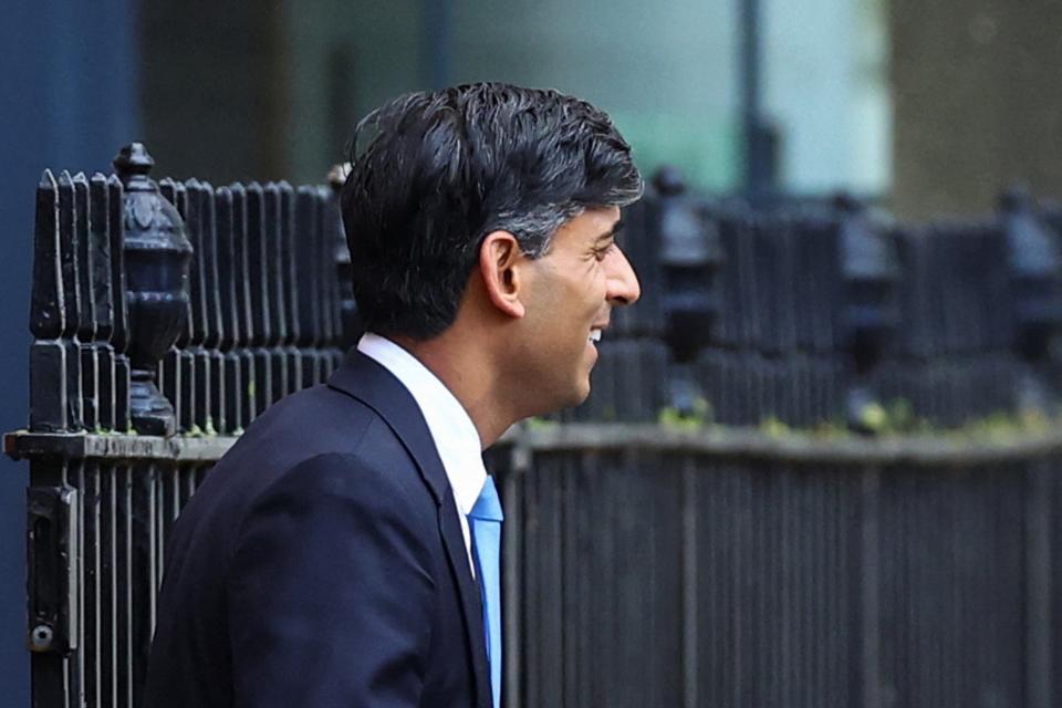 British Prime Minister Rishi Sunak walks outside 10 Downing Street in London on Tuesday (REUTERS)