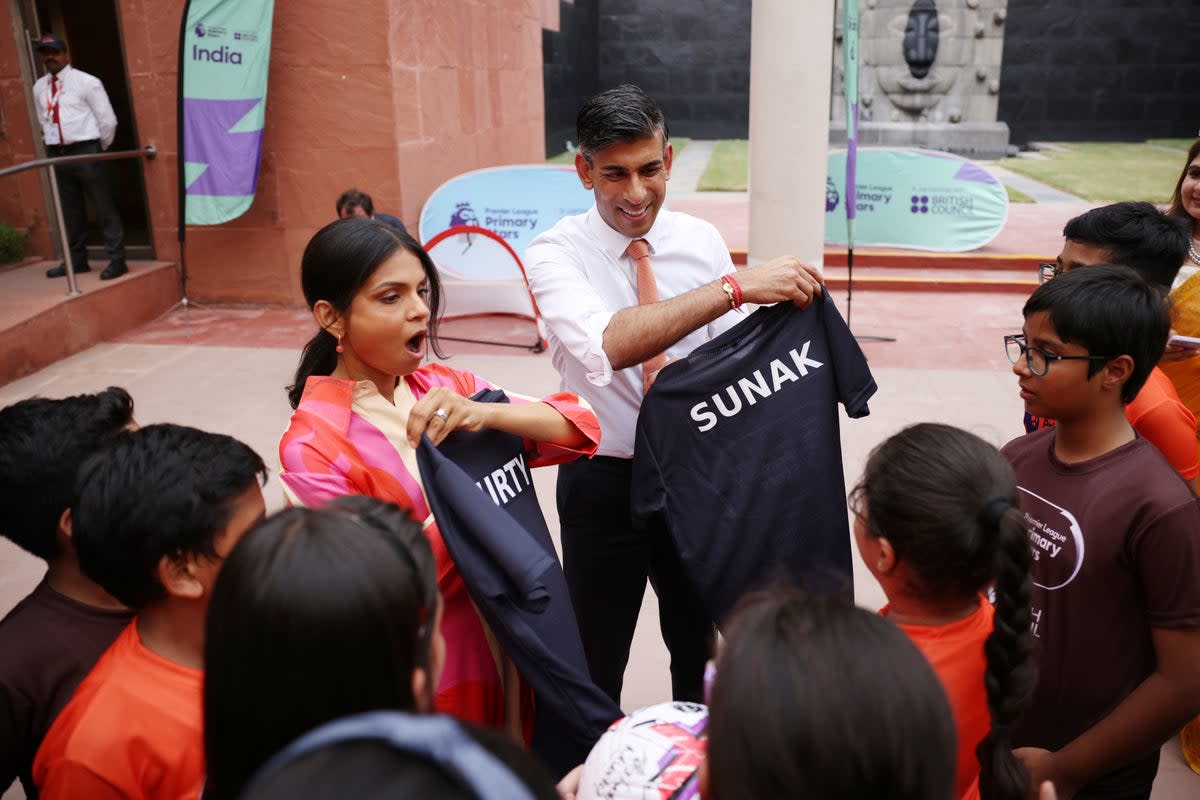 Prime Minister Rishi Sunak and his wife Akshata Murty meet local schoolchildren at the British Council (PA)