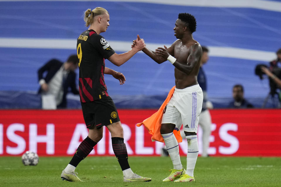 Manchester City's Erling Haaland, left, greets Real Madrid's Vinicius Junior at the end of the Champions League semifinal first leg soccer match between Real Madrid and Manchester City at the Santiago Bernabeu stadium in Madrid, Spain, Tuesday, May 9, 2023. (AP Photo/Manu Fernandez)
