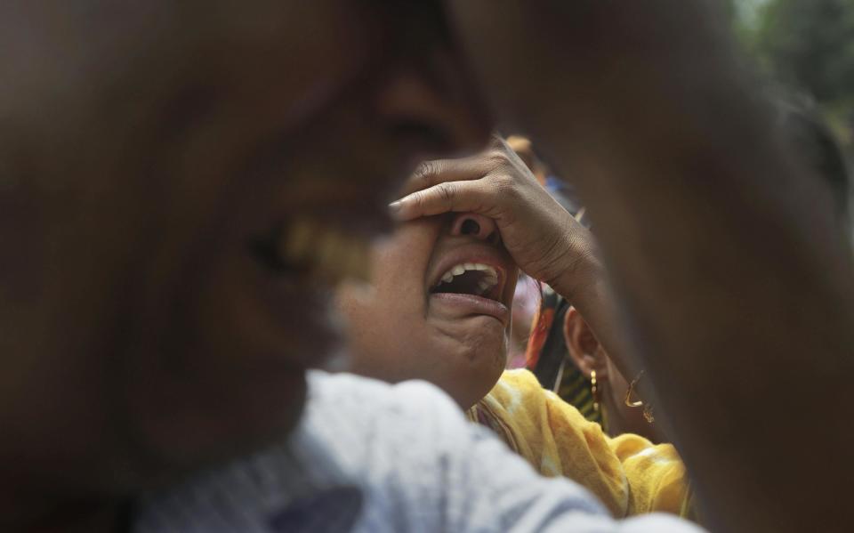 Relatives of victims killed in ethnic violence mourn at a cremation ground at Narayanguri village, in the northeastern Indian state of Assam, Saturday, May 3 2014. Police in India arrested 22 people after separatist rebels went on a rampage, burning homes and killing dozens of Muslims in the worst outbreak of ethnic violence in the remote northeastern region in two years, officials said Saturday. (AP Photo/Anupam Nath)