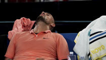 Australia's Nick Kyrgios rests in his chair after defeating Russia's Karen Khachanov in their third round singles match at the Australian Open tennis championship in Melbourne, Australia, Saturday, Jan. 25, 2020. (AP Photo/Lee Jin-man)