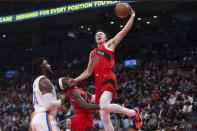 Toronto Raptors' Yuta Watanabe drives to the basket as Oklahoma City Thunder's Derrick Favors defends during the first half of an NBA basketball game Wednesday, Dec. 8, 2021, in Toronto. (Chris Young/The Canadian Press via AP)