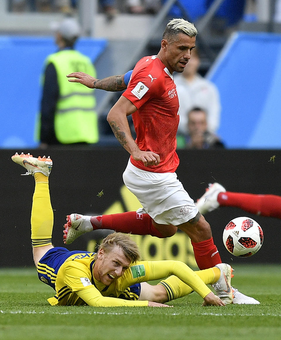 <p>Switzerland’s Valon Behrami, rear, and Sweden’s Emil Forsberg challenge for the ball during the round of 16 match between Switzerland and Sweden at the 2018 soccer World Cup in the St. Petersburg Stadium, in St. Petersburg, Russia, Tuesday, July 3, 2018. (AP Photo/Martin Meissner) </p>