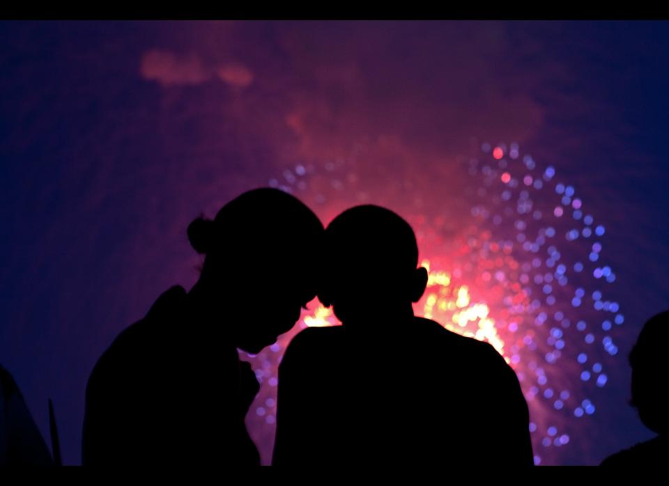 President Barack Obama and First Lady Michelle Obama watch the fireworks over the National Mall from the roof of the White House, July 4, 2010.     