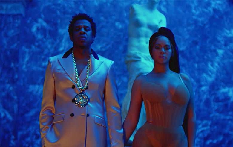 <p>With the Louvre as their backdrop, Beyoncé and Jay-Z created tableaus that mixed high art, fashion, and performance throughout their Apes**t music video. In this scene, Beyoncé is standing under the <em>Venus de Milo</em>, her body mimicking the s-curve of the sculpture in reverse with her chest and hip outwards rather than concave. As a model for Western, Euro-centric beauty, the Venus (also known as the Greek goddess Aphrodite) juxtaposes Beyoncé's stance on black female empowerment. The goddess also represents love, fertility, and desire, which Beyoncé channels through her barely-there bodysuit and her proud stance next to her husband.</p>