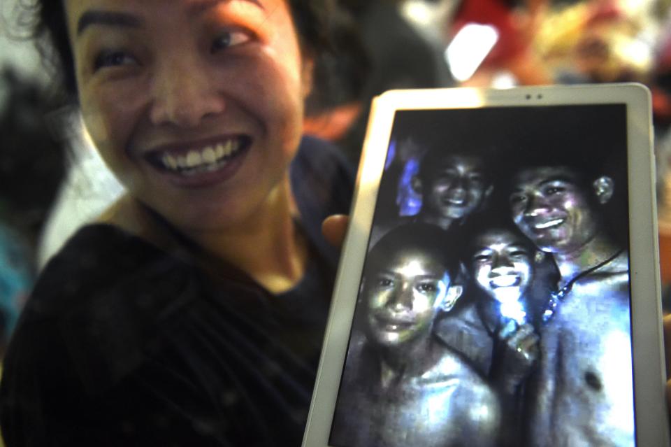 <span>A family member smiles after hearing the news that the missing 12 boys and their soccer coach have been found, in Mae Sai, Chiang Rai province, in northern Thailand, Monday, July 2, 2018. A Thai provincial governor says all 12 boys and their coach have been found alive in the cave where they went missing over a week ago in northern Thailand. (AP Photo/Sakchai Lalit)</span>