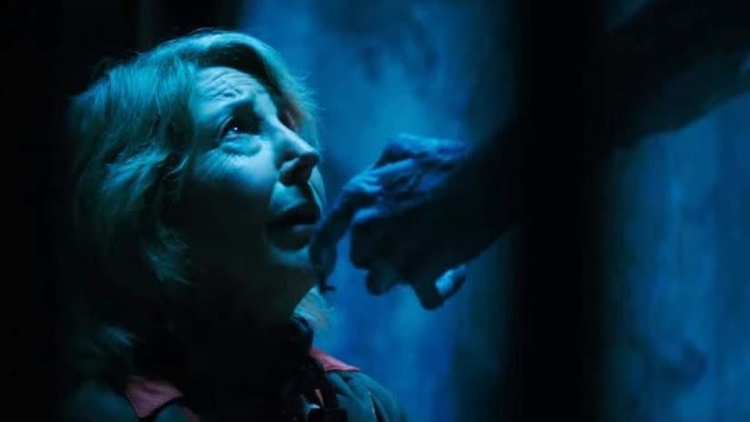 a demon with keys for fingers touches elise's face in a scene from insidious the last key
