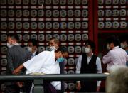 Visitors wearing protective face masks are seen at a shrine amid the coronavirus disease (COVID-19) outbreak, in Tokyo