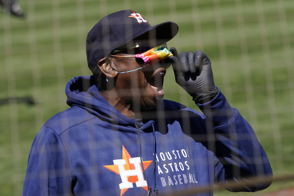 Houston Astros manager Dusty Baker Jr. lifts his face mask as he looks toward fans during the seventh inning of the team's baseball game against the Oakland Athletics in Oakland, Calif., Thursday, May 20, 2021. (AP Photo/Jeff Chiu)