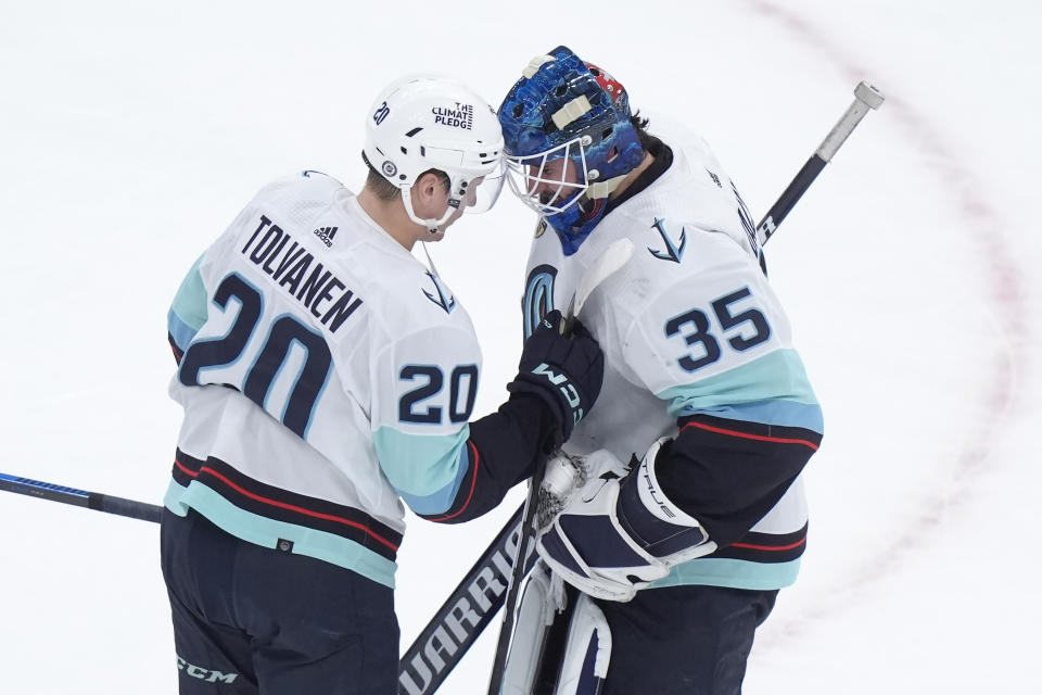 Seattle Kraken right wing Eeli Tolvanen (20) celebrates with goaltender Joey Daccord (35) after defeating the Boston Bruins in an NHL hockey game, Thursday, Feb. 15, 2024, in Boston. (AP Photo/Steven Senne)